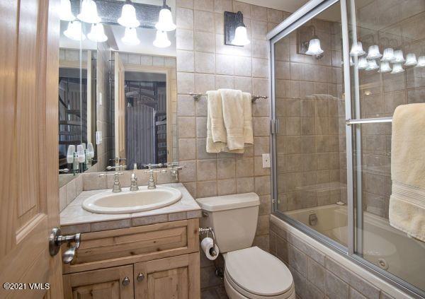 225 Wall Street, Unit 302 Vail, CO 81657 - Photo 14 of 19 a bathroom with a sink a toilet and shower