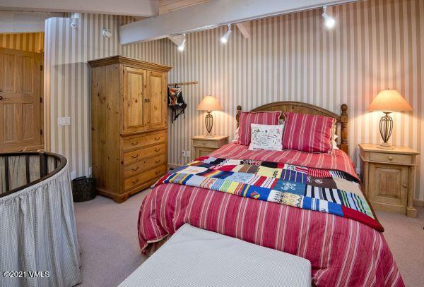 225 Wall Street, Unit 302 Vail, CO 81657 - Photo 15 of 19 a bedroom with a bed and a table
