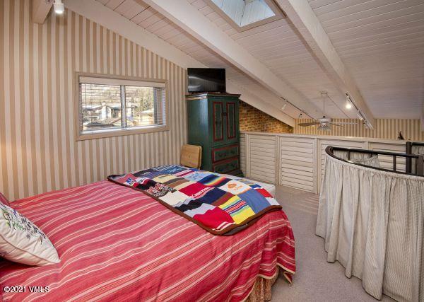 225 Wall Street, Unit 302 Vail, CO 81657 - Photo 16 of 19 a bedroom with a bed and a window