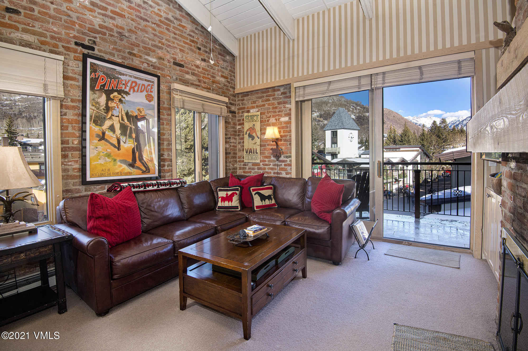 225 Wall Street, Unit 302 Vail, CO 81657 - Photo 3 of 19 a living room with furniture a flat screen tv and a large window