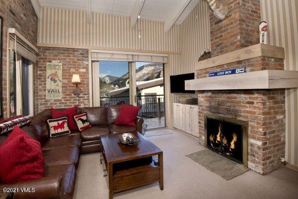 225 Wall Street, Unit 302 Vail, CO 81657 - Photo 7 of 19 a living room with furniture and a fireplace