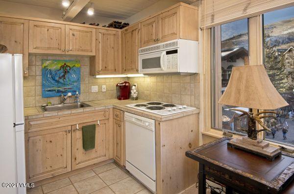 225 Wall Street, Unit 302 Vail, CO 81657 - Photo 10 of 19 a kitchen with a sink cabinets and window