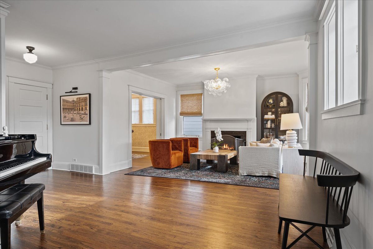 615 Abbotsford Road Kenilworth, IL 60043 - Photo 4 of 47 a living room with fireplace furniture and a wooden floor