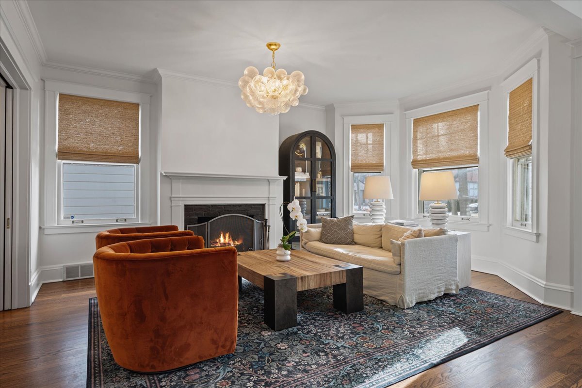 615 Abbotsford Road Kenilworth, IL 60043 - Photo 6 of 47 a living room with furniture a table and a fireplace
