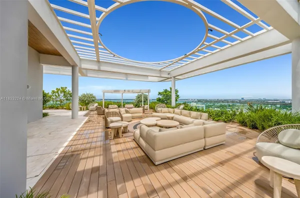 a living room with patio furniture and a large window