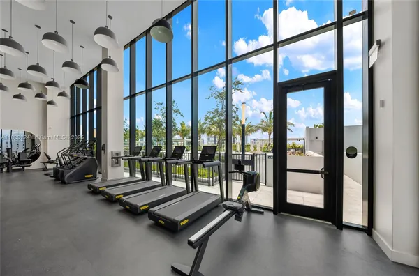 a room with lots of windows and view of living room