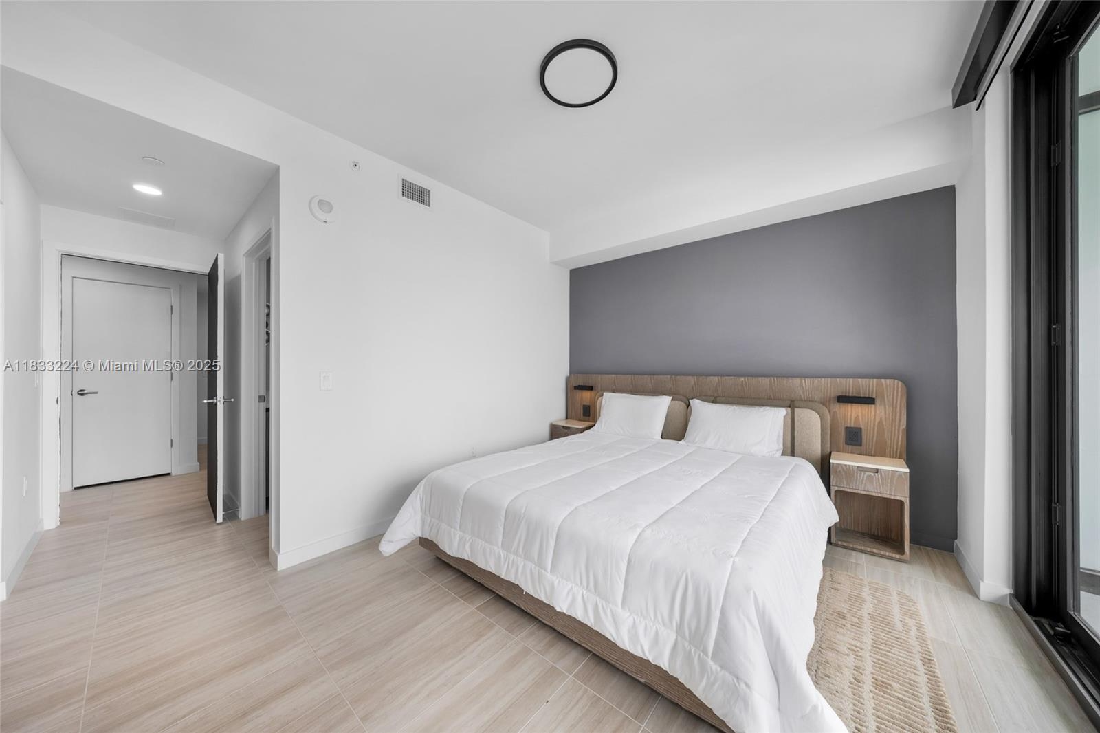 580 72nd Street, Unit 910 Miami Beach, FL 33141 - Photo 39 of 46 a bedroom with a bed and a table