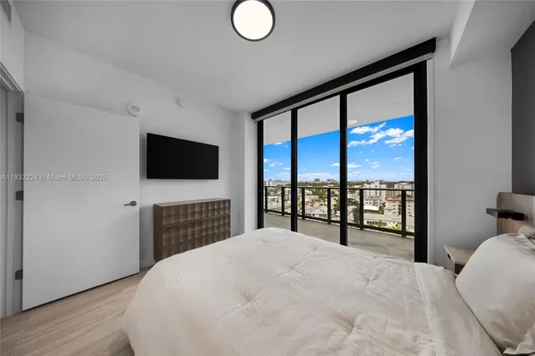 a view of a livingroom with furniture a flat screen tv and outdoor view