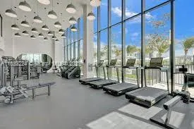 a room with gym equipment and a large window