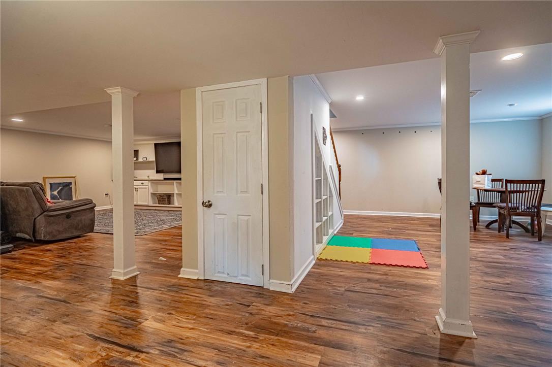 102 Sutton Road Easton, PA 18045 - Photo 60 of 83 Rich wood-look flooring and support columns define this versatile, fully finished lower level layout.