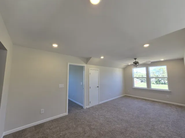 an empty room with windows and closet