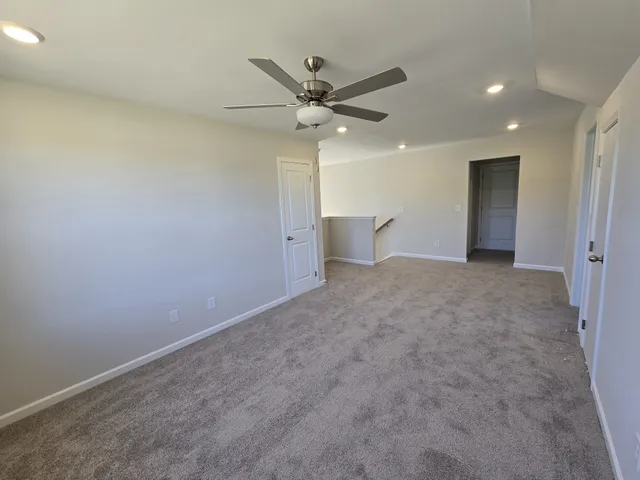 a view of a livingroom with a ceiling fan and window