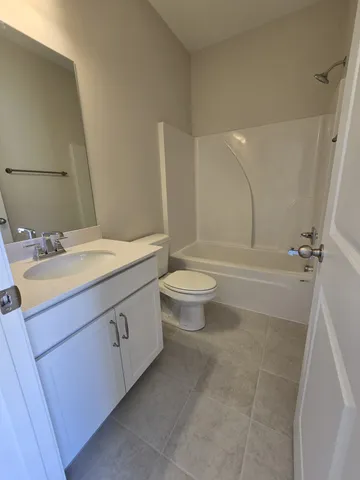 a bathroom with a sink a toilet and a large mirror