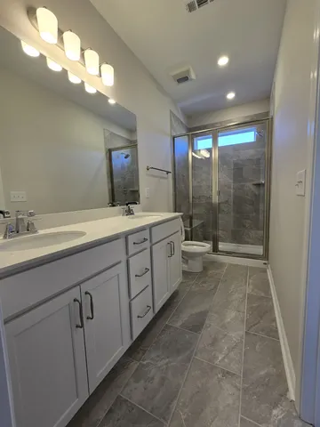 a spacious bathroom with a mirror a double vanity sink and a mirror