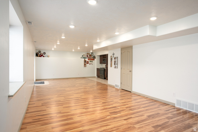 426 Deer Hollow Road Tooele, UT 84074 - Photo 21 of 37 Unfurnished room featuring light wood-style flooring and recessed lighting