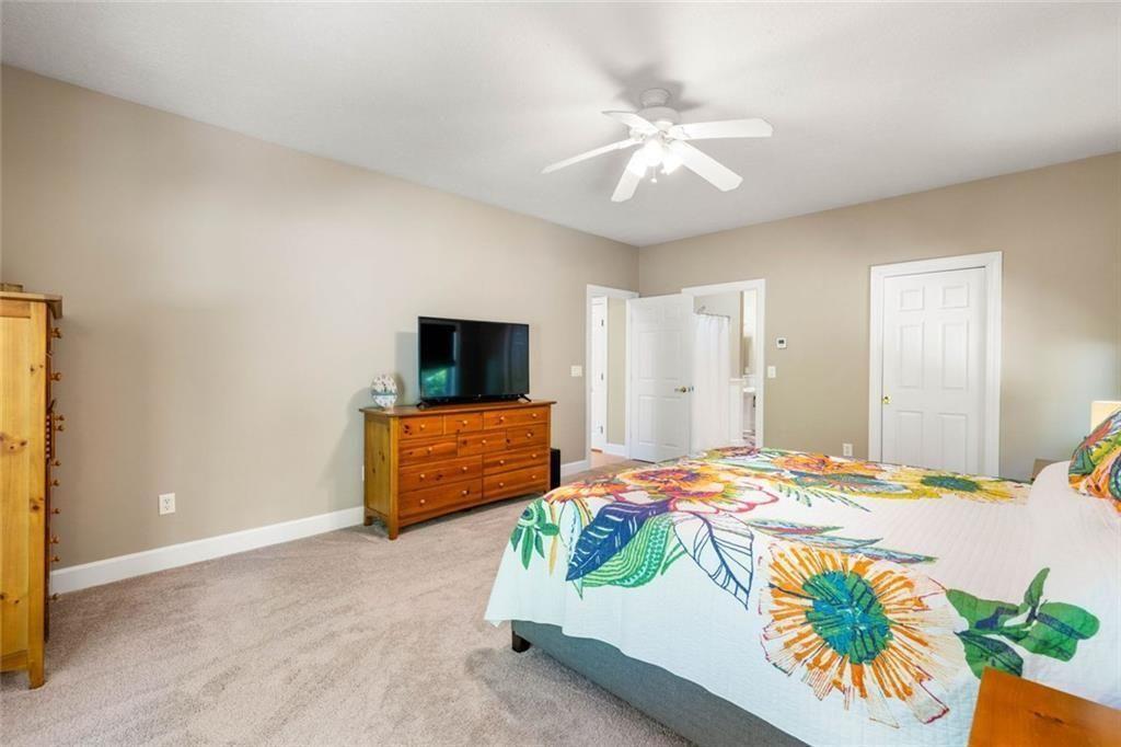 704 Riverbend Road Blairsville, GA 30512 - Photo 47 of 89 a bedroom with a bed and a flat screen tv