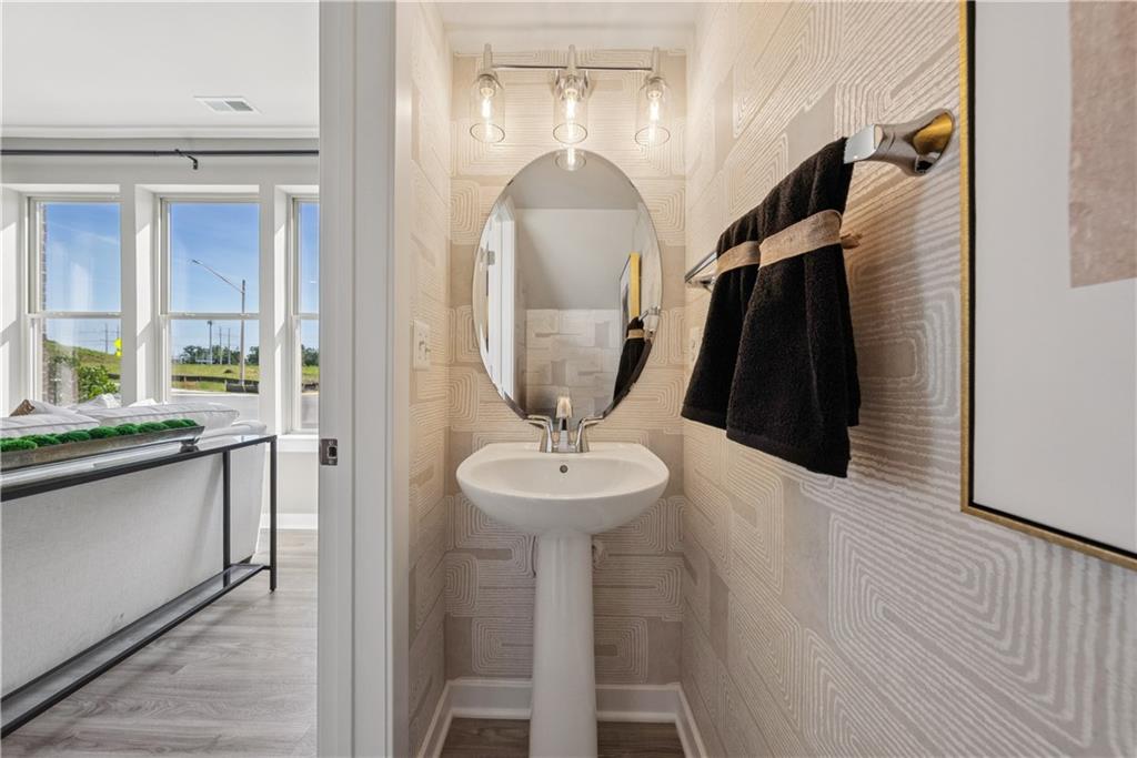 306 Skylar Court Southeast, Unit 89 Atlanta, GA 30312 - Photo 11 of 26 a bathroom with a sink and a mirror