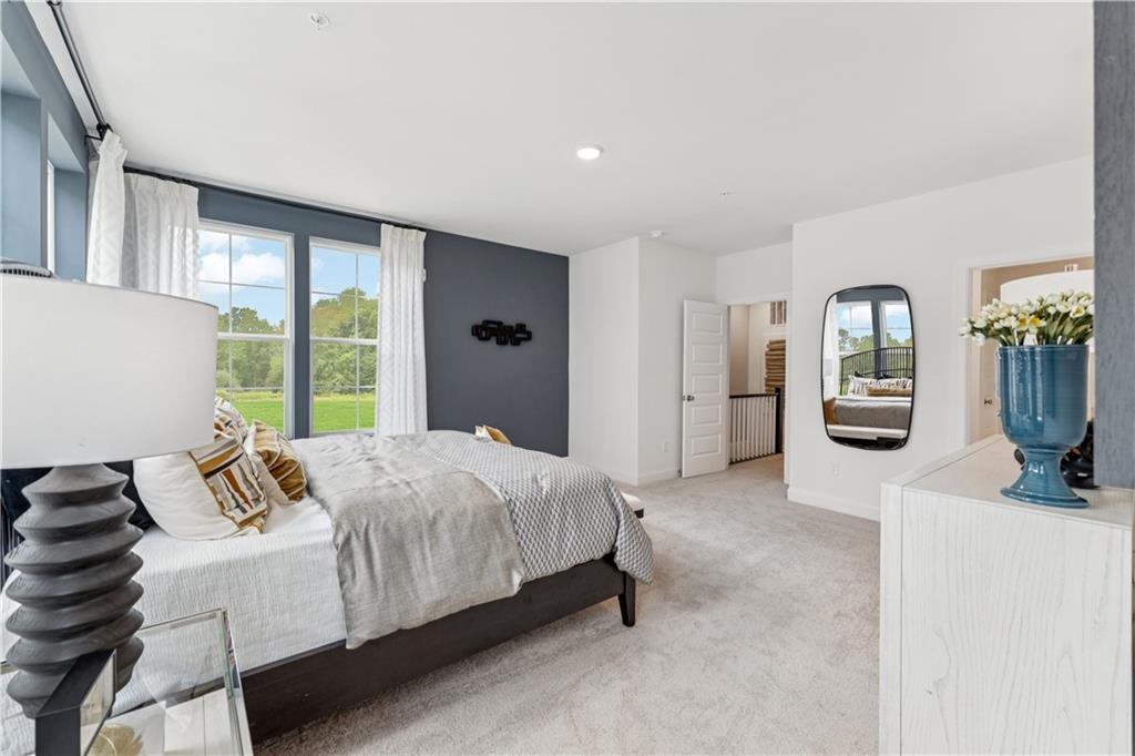 306 Skylar Court Southeast, Unit 89 Atlanta, GA 30312 - Photo 14 of 26 a bedroom with a bed and potted plants next to a large window