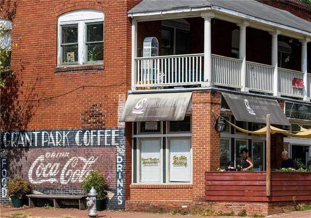a view of a brick house with large windows