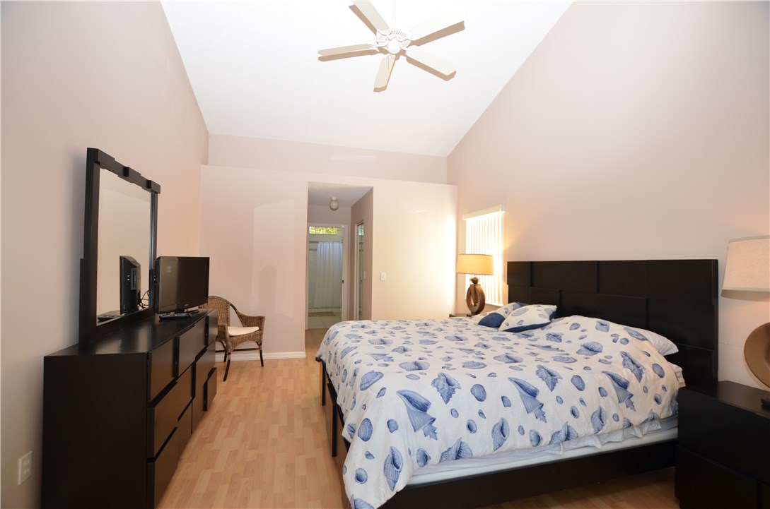155 Midvale Terrace Sebastian, FL 32958 - Photo 13 of 16 a bedroom with a bed and a flat screen tv