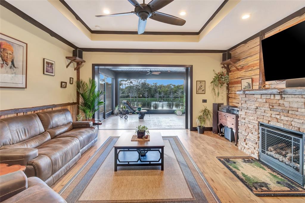 7330 Crabgrass Road St. Cloud, FL 34773 - Photo 29 of 60 a living room with fireplace furniture and a flat screen tv