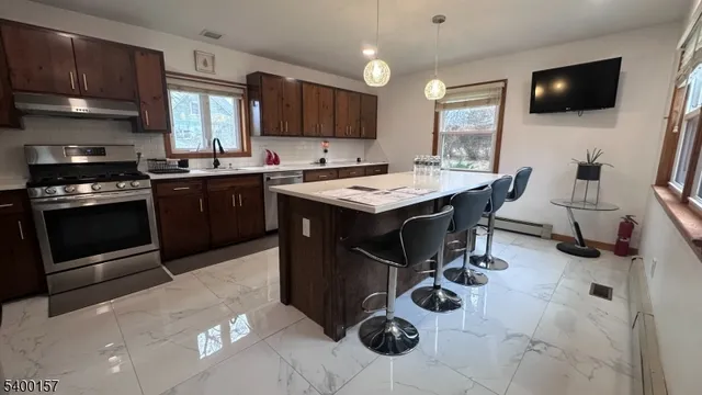 a kitchen with a sink stainless steel appliances and cabinets