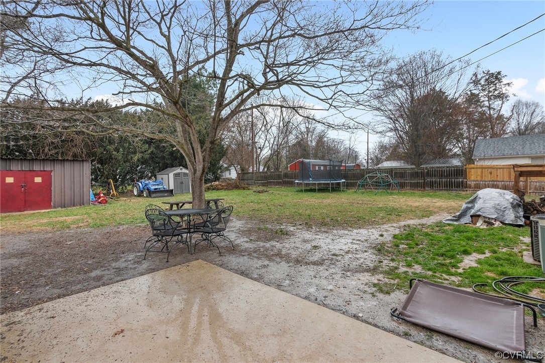 5920 Brookfield Road Richmond, VA 23227 - Photo 33 of 35 View of yard featuring a patio, a storage shed, an
