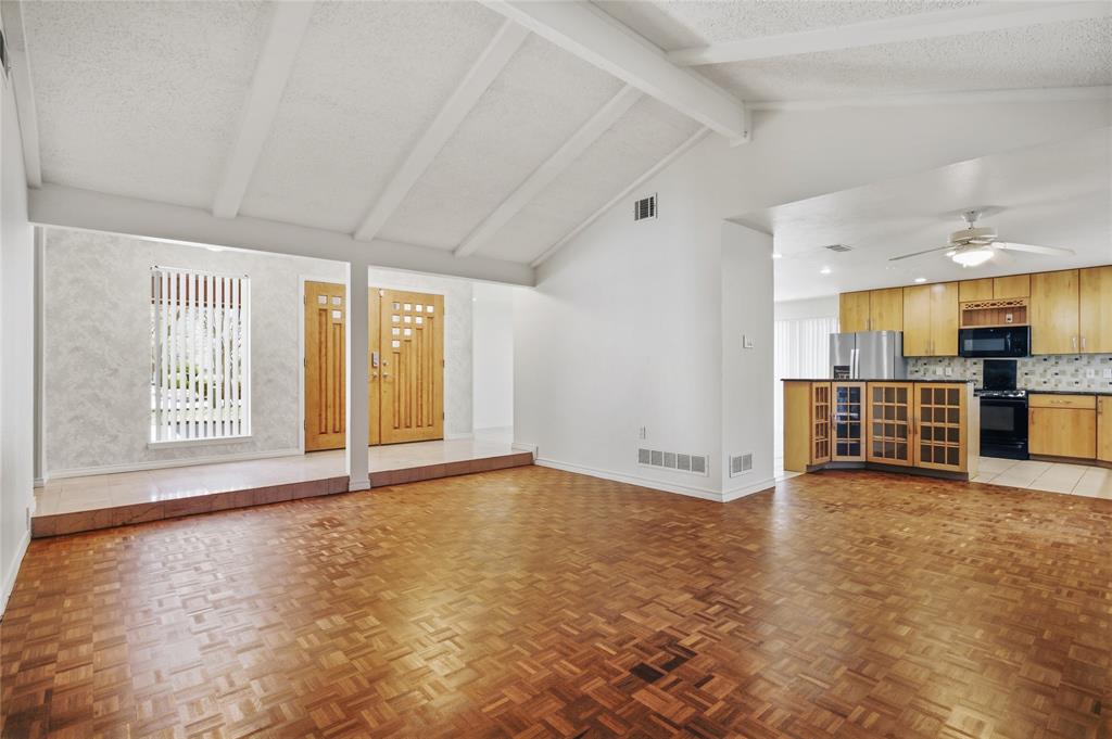 15721 Mapleview Circle Dallas, TX 75248 - Photo 6 of 40 an empty room with large windows