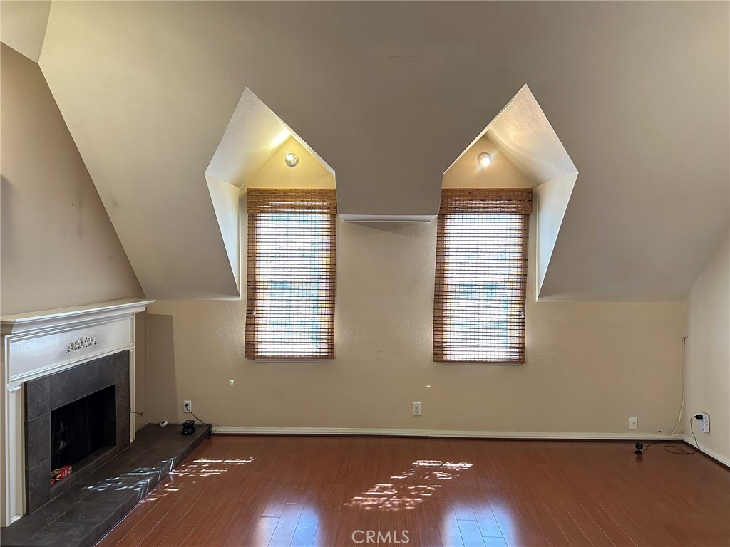 300 South Timken Road Anaheim, CA 92808 - Photo 18 of 40 an empty room with wooden floor fireplace and windows