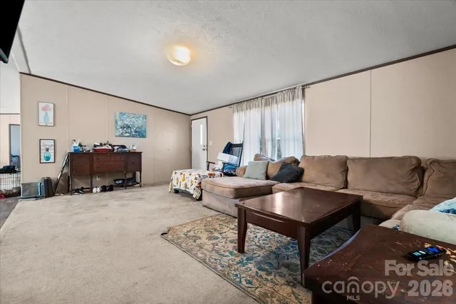 a living room with furniture and a dining table