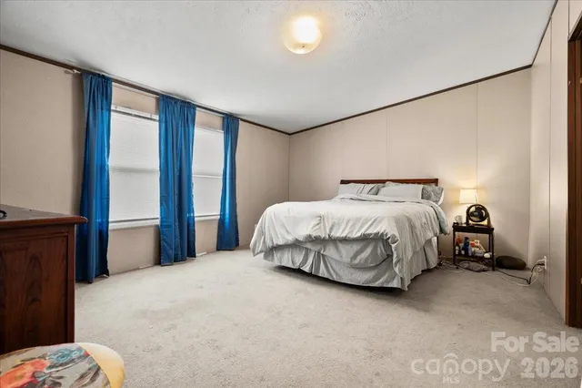 a bedroom with a bed and a mirror