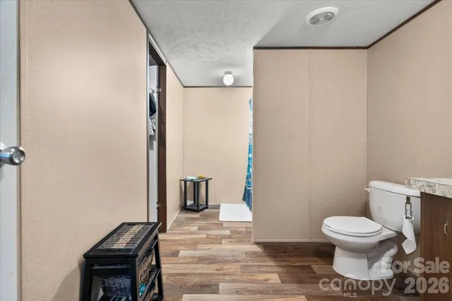 a bathroom with a toilet and a shower