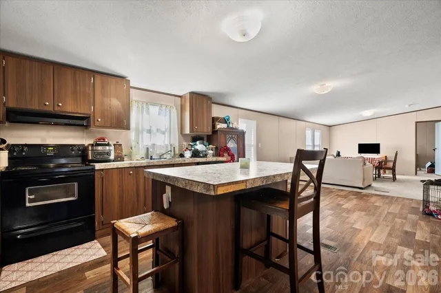 a kitchen with a table chairs stove and cabinets