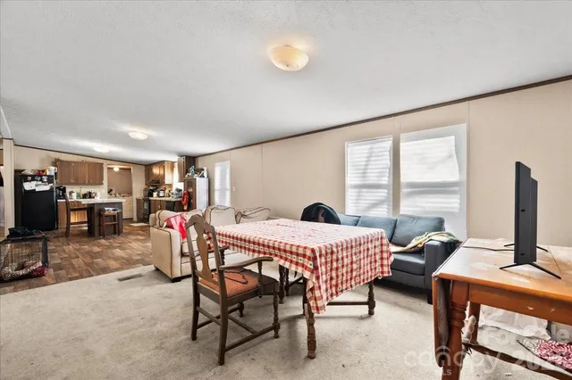 a bedroom with furniture and a flat screen tv