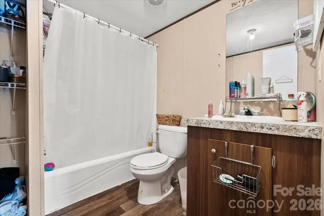 a bathroom with a sink a toilet and a shower