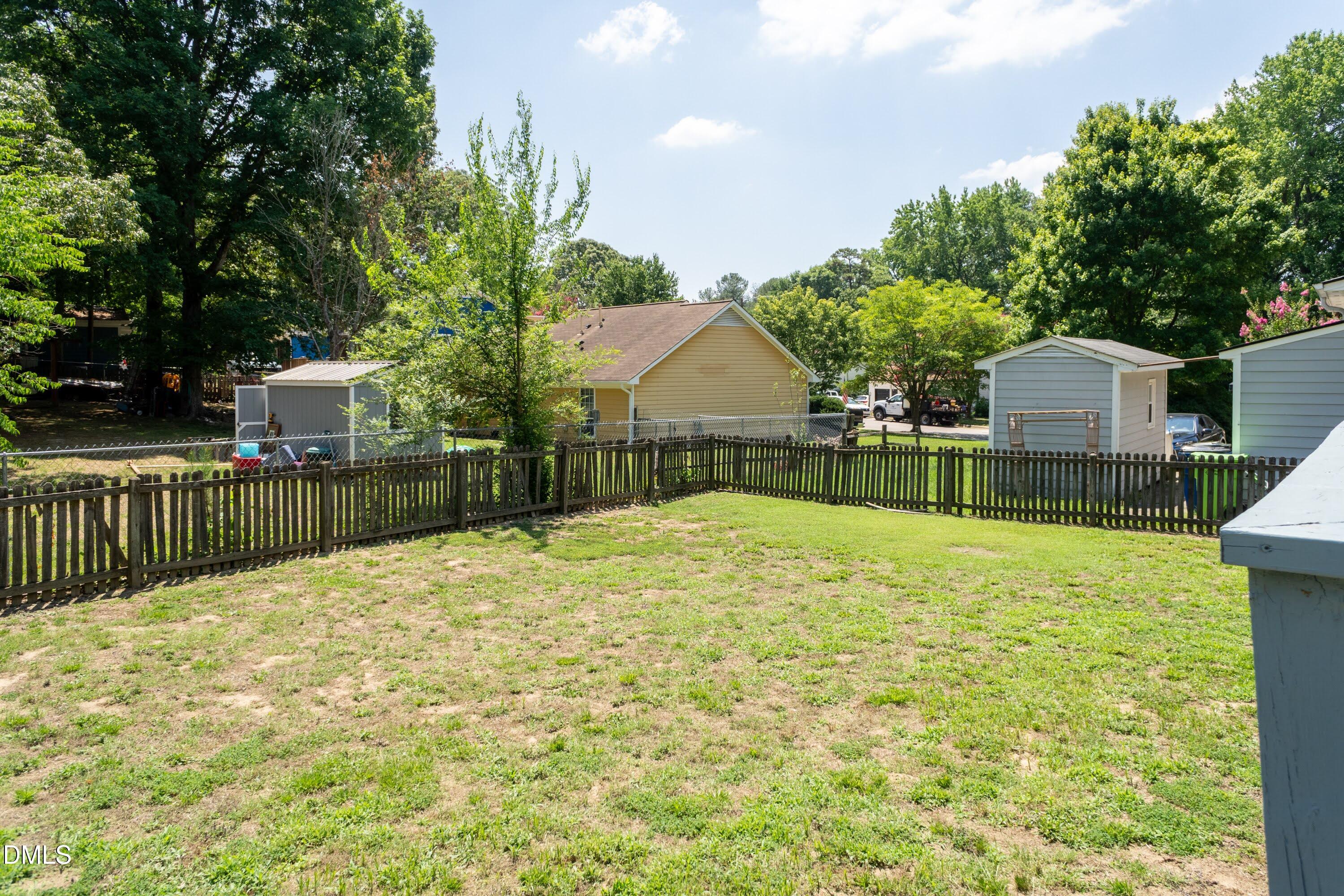 5604 Spring Pines Way Raleigh, NC 27616 - Photo 20 of 22 a backyard of a house with table and chairs