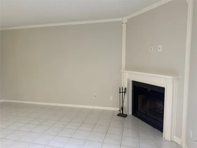 a view of an empty room with a fireplace