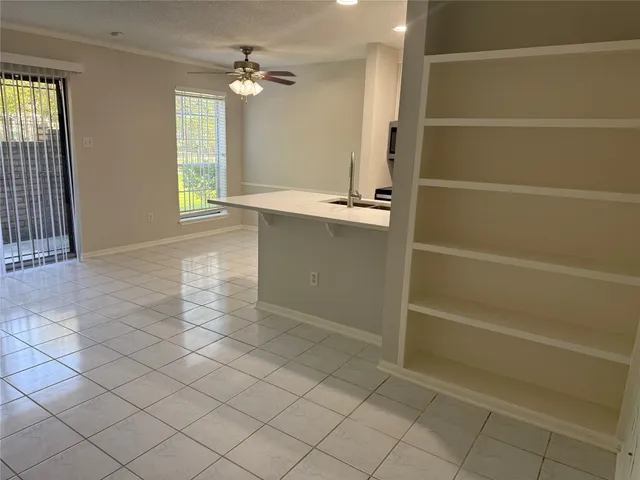 a metallic refrigerator freezer sitting in a kitchen