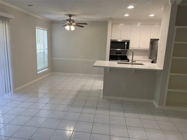 a kitchen with kitchen island granite countertop a stove a sink and a refrigerator