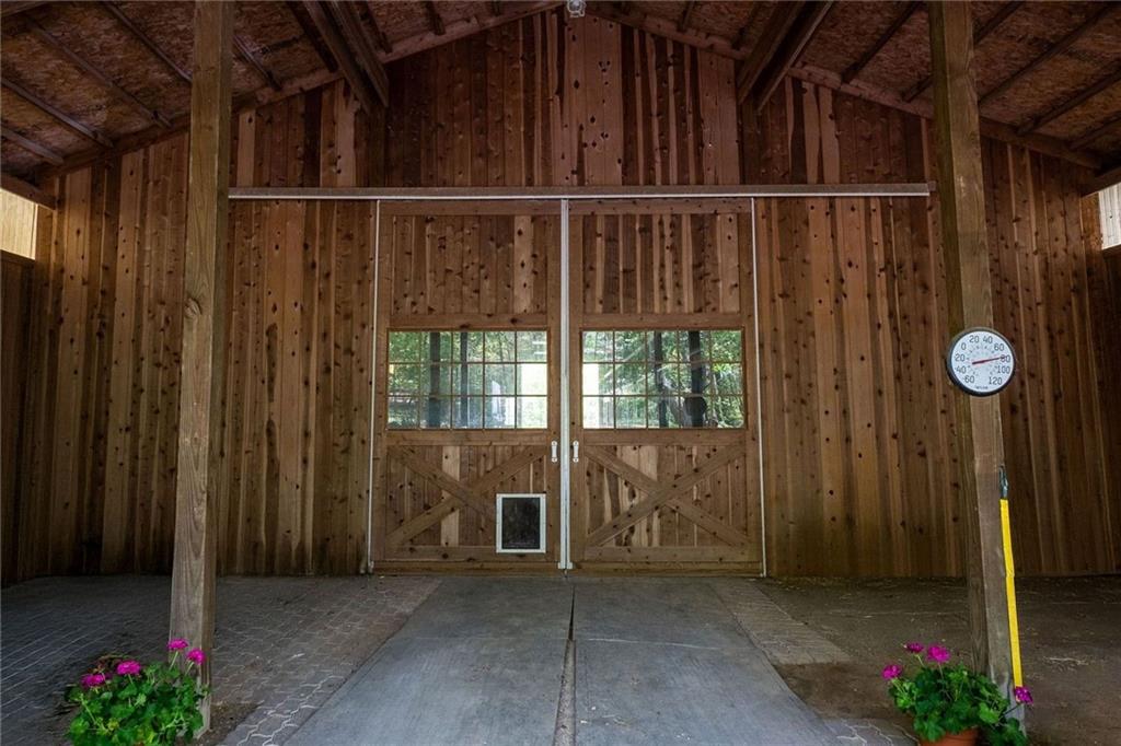45 Stonedale Road Sewickley, PA 15143 - Photo 9 of 26 The barn’s double sliding doors and wood-paneled interior provide a warm, rustic feel while offering practical functionality for livestock or storage.