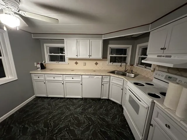 a kitchen with a sink stove and cabinets