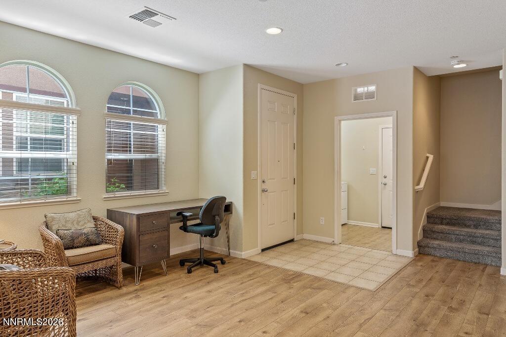 1864 Wind Ranch Road, Unit B Reno, NV 89521 - Photo 5 of 42 a view of a livingroom with workspace and a window