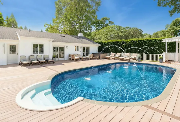 a view of a swimming pool with lounge chair