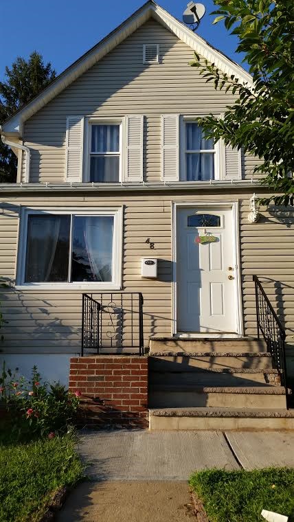 48 Preston Street Ridgefield Park, NJ 07660 - Photo 1 of 1 a front view of a house with a yard