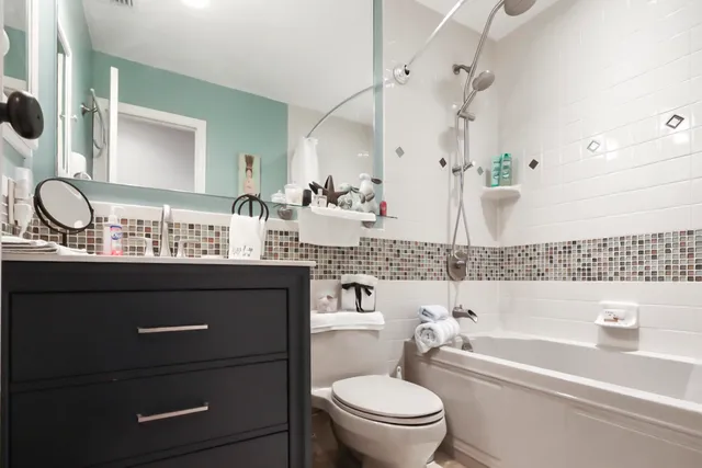 a bathroom with a bathtub a sink and a mirror