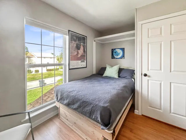 a bedroom with a bed and a window