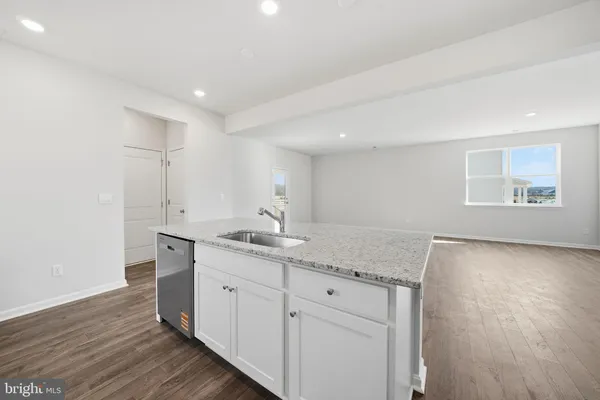 a bathroom with a granite countertop sink and a window