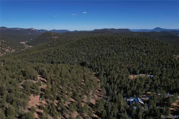 a view of a town with mountains in the background