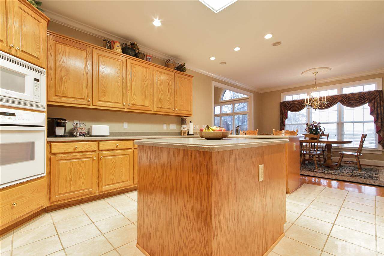 864 Rivers Edge Drive Graham, NC 27253 - Photo 10 of 25 Bright Kitchen Area with Breakfast Bar and Entrance into Dining Area