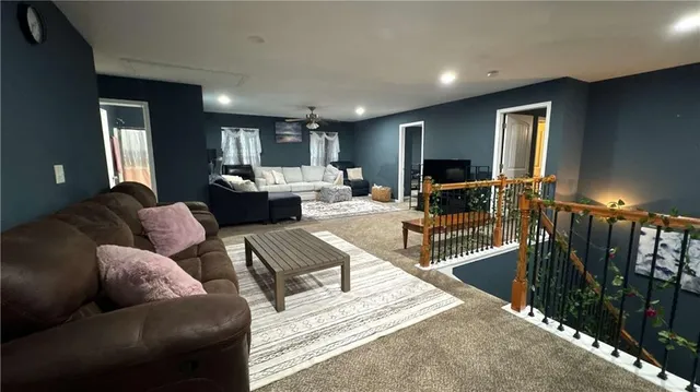 a living room with furniture fireplace and a window